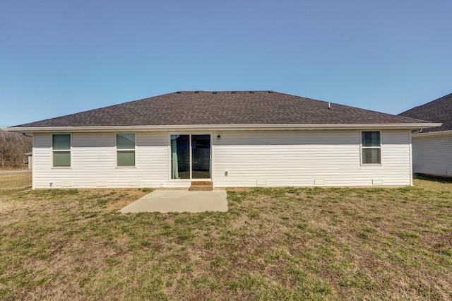 rear view of property featuring a patio, a yard, and roof with shingles