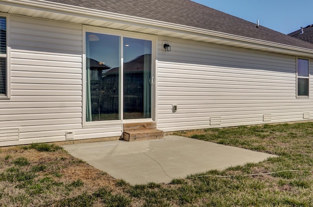 exterior space featuring a patio and roof with shingles