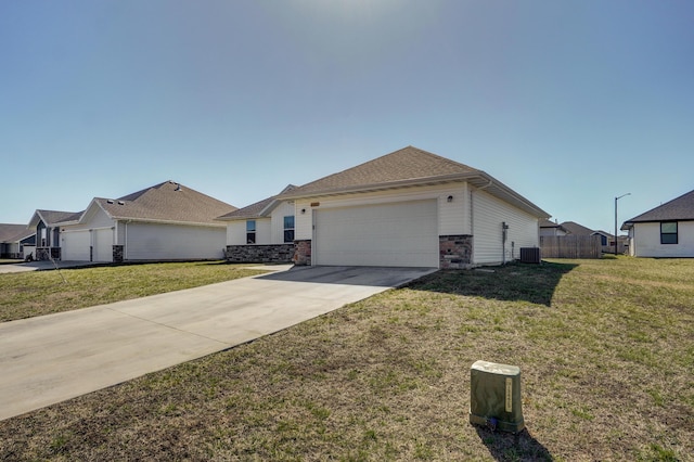 ranch-style home with a front lawn, central AC, fence, concrete driveway, and a garage