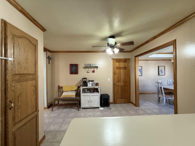 living room with baseboards, a ceiling fan, light tile patterned flooring, and crown molding