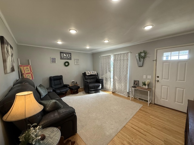 living area with light wood finished floors and ornamental molding