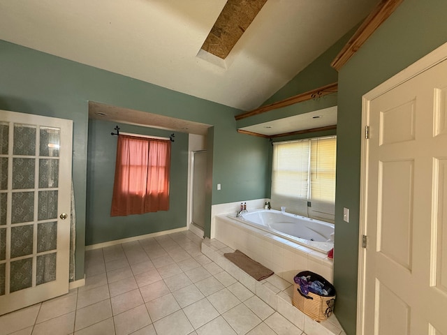 bathroom with tile patterned floors, a shower stall, a garden tub, and vaulted ceiling