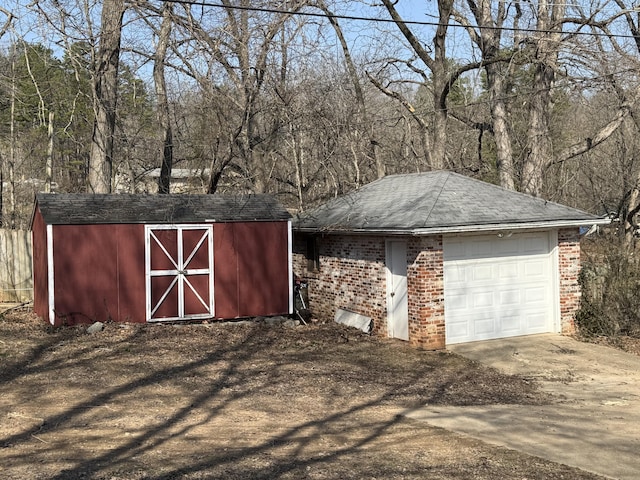 view of shed featuring driveway and an attached garage