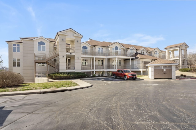 view of property featuring a residential view and uncovered parking