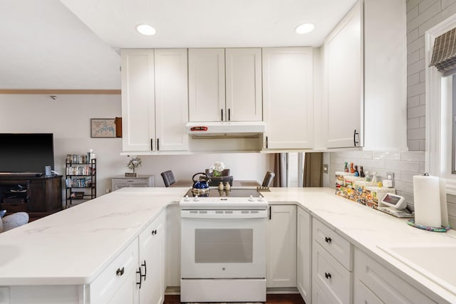 kitchen featuring white cabinets, light stone counters, under cabinet range hood, and white range with electric cooktop