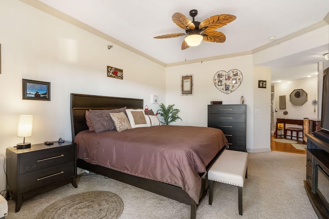 bedroom featuring ceiling fan, baseboards, light carpet, and ornamental molding