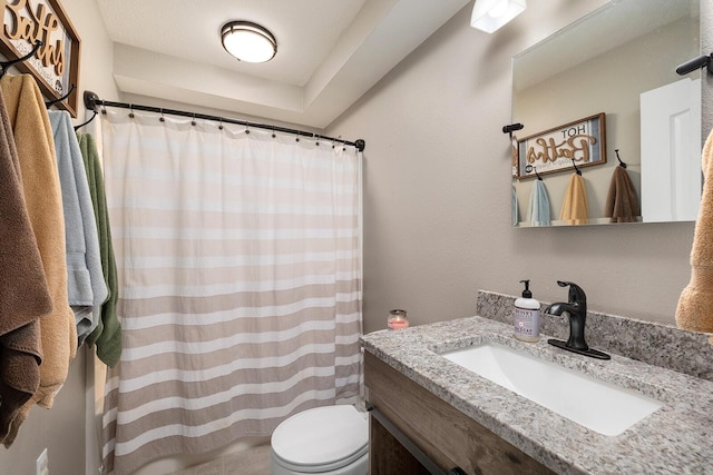 bathroom with a shower with curtain, toilet, and vanity