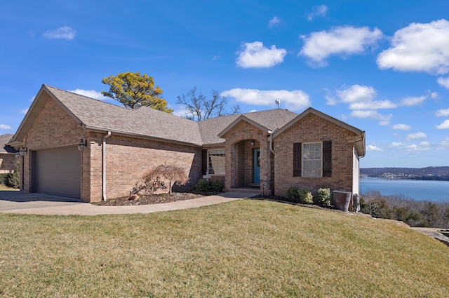 single story home featuring brick siding, a shingled roof, a front lawn, concrete driveway, and an attached garage