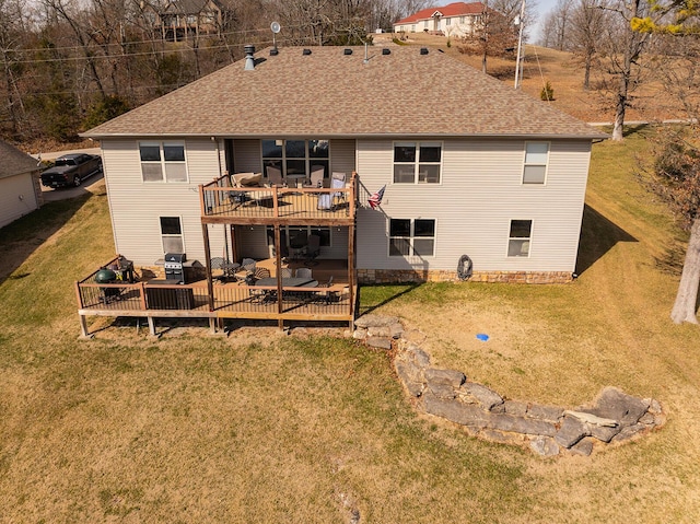 back of property with a lawn, roof with shingles, and a wooden deck