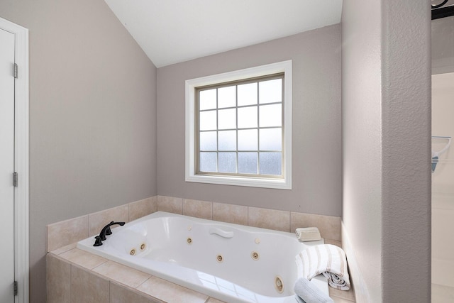 full bathroom with a whirlpool tub and vaulted ceiling