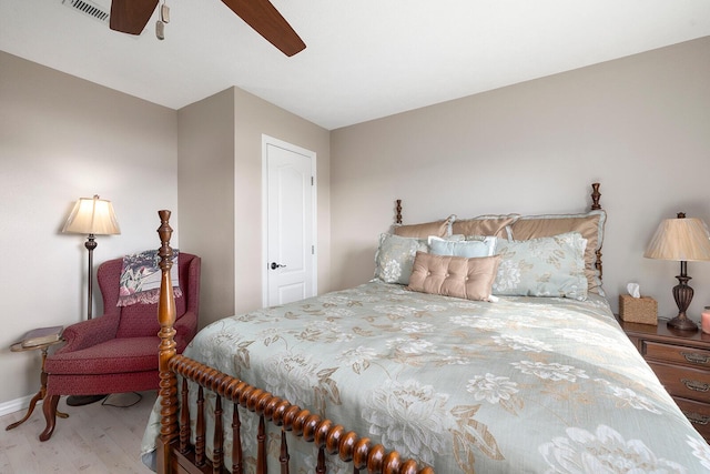 bedroom with visible vents, ceiling fan, and wood finished floors