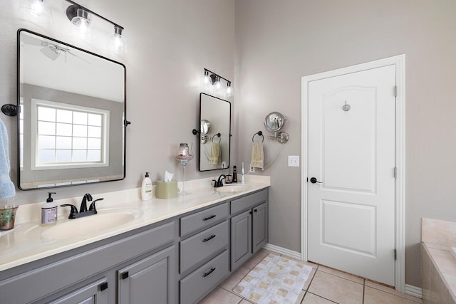 bathroom featuring tile patterned flooring, double vanity, a washtub, and a sink