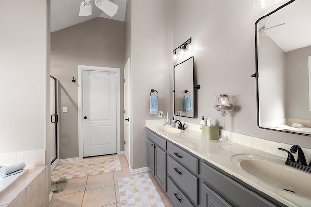 bathroom featuring double vanity, a shower stall, lofted ceiling, and a sink