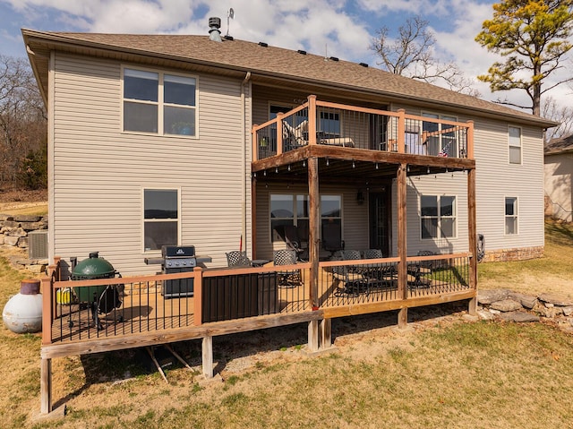 rear view of property with central air condition unit and a wooden deck