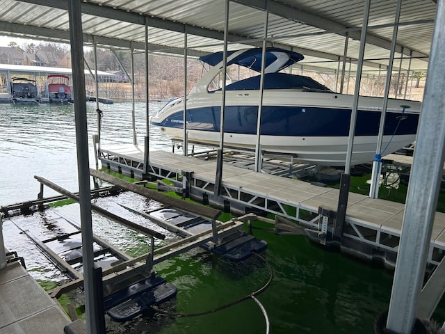 view of dock with boat lift and a water view