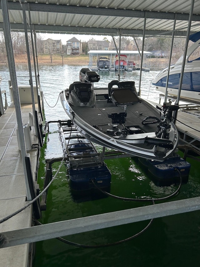 dock area with a water view and boat lift