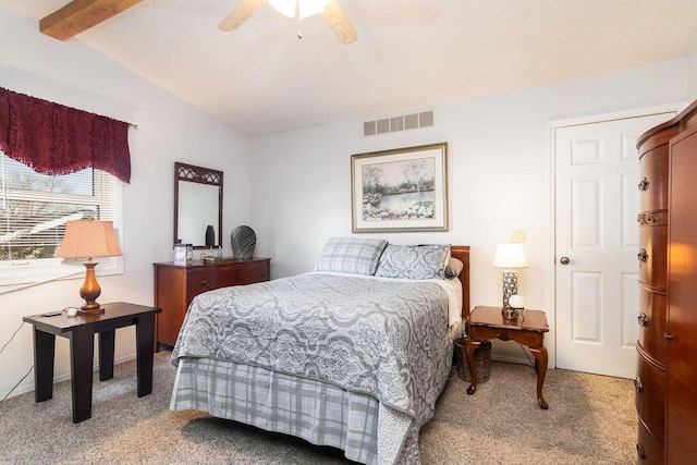 bedroom featuring ceiling fan, lofted ceiling with beams, visible vents, and light carpet