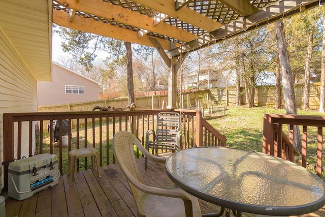 wooden deck featuring a yard, outdoor dining space, a pergola, and a fenced backyard