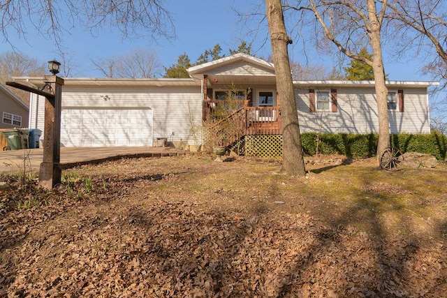 rear view of property featuring a garage, a porch, and concrete driveway