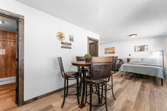 dining area featuring baseboards and wood finished floors