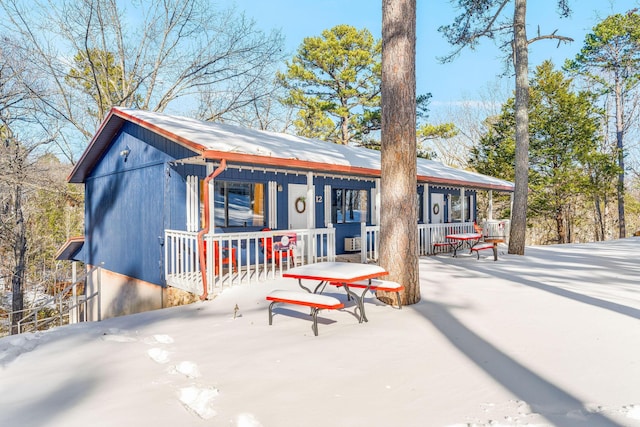 back of house featuring covered porch