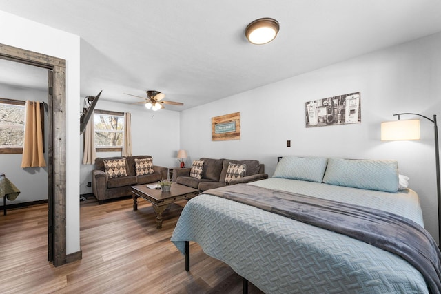 bedroom featuring light wood-style flooring and ceiling fan