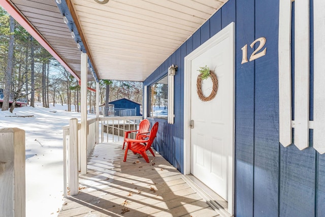 wooden terrace featuring covered porch