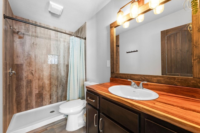 bathroom featuring vanity, curtained shower, and toilet