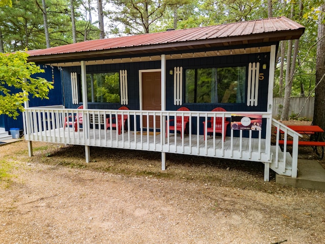 exterior space with covered porch and metal roof