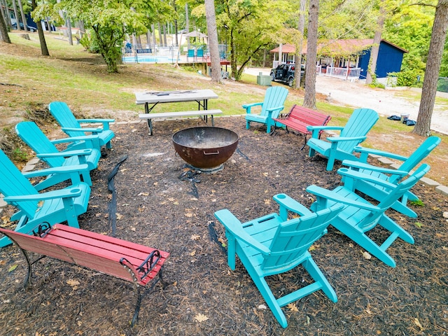 view of home's community featuring an outdoor fire pit