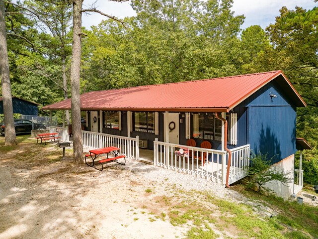 view of front of property with a porch and metal roof