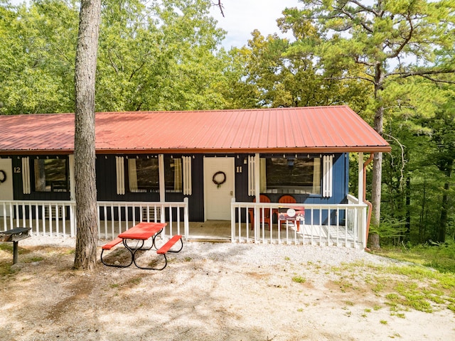 view of front of home featuring a porch and metal roof