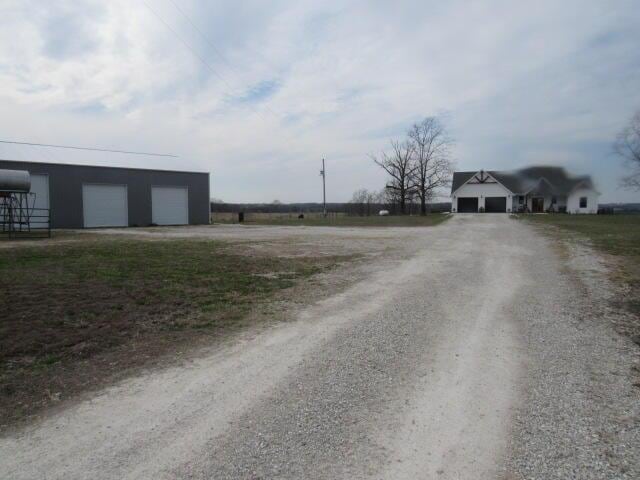 view of street featuring dirt driveway