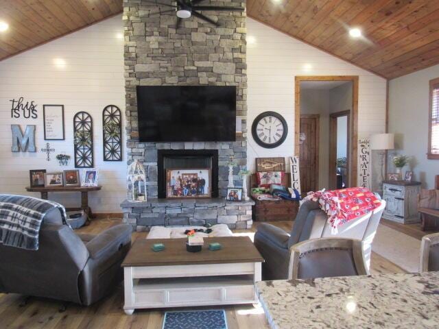 living room with high vaulted ceiling, wood ceiling, wood finished floors, and a fireplace