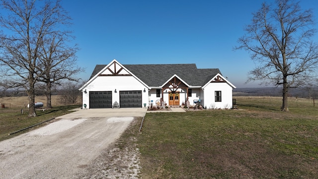 modern farmhouse style home with driveway, an attached garage, and a front yard