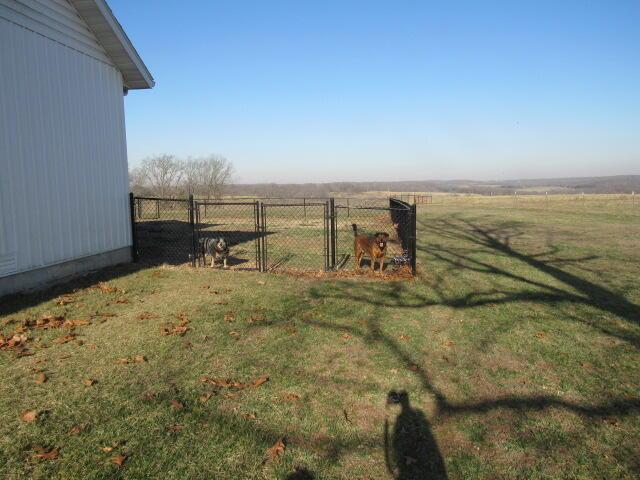 view of yard featuring a rural view and fence