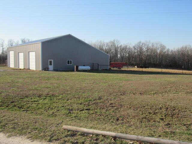 view of pole building with a yard