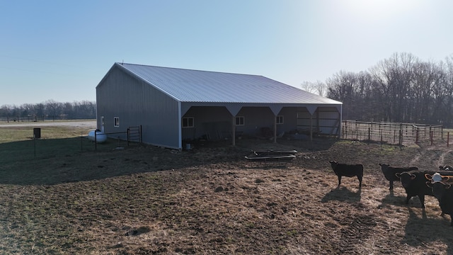 view of pole building featuring a rural view and fence