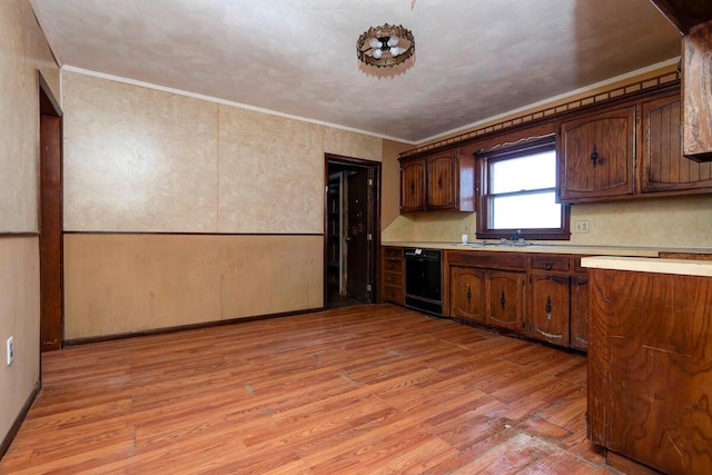 kitchen featuring dishwasher, light countertops, light wood-style flooring, and ornamental molding