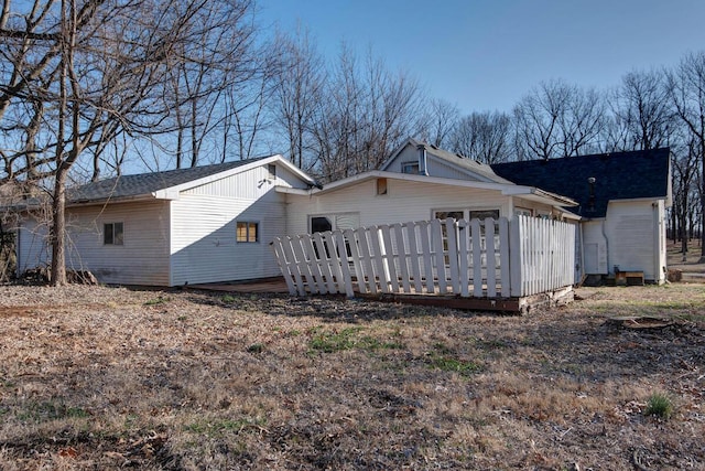 rear view of house featuring a wooden deck