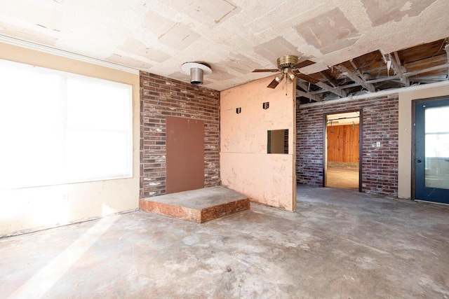 exterior space featuring brick wall and unfinished concrete flooring