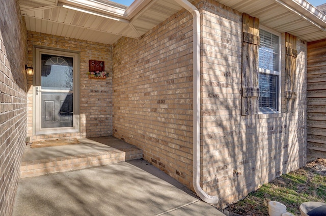 property entrance with brick siding