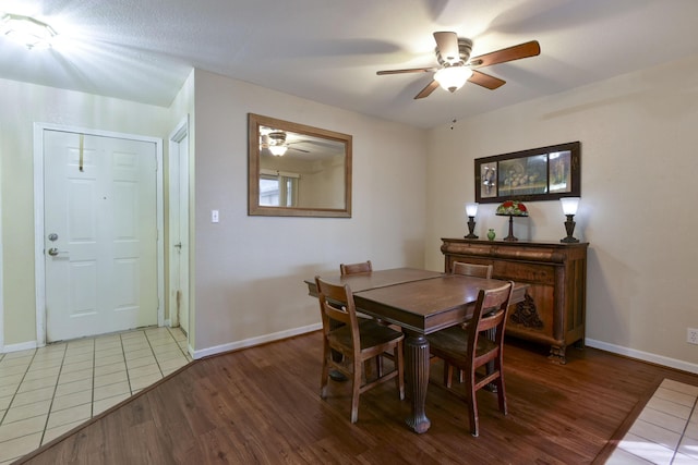 dining room featuring wood finished floors, baseboards, and ceiling fan