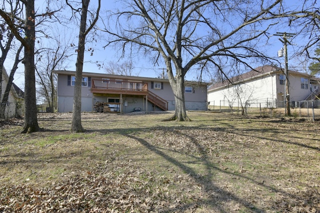 rear view of house featuring stairs, fence, and a wooden deck