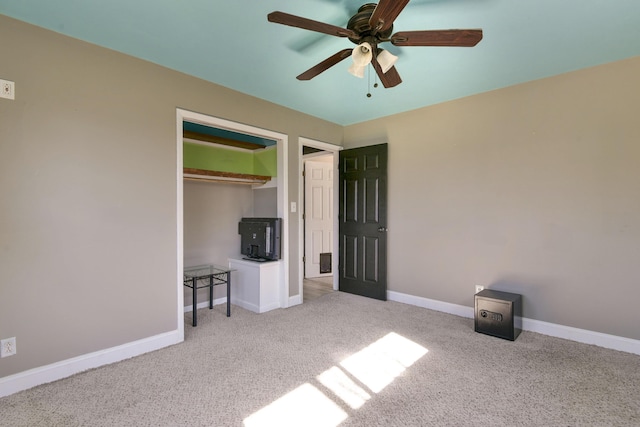 unfurnished bedroom featuring a closet, ceiling fan, baseboards, and carpet