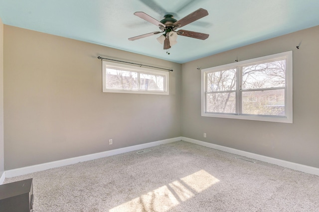 empty room featuring ceiling fan, baseboards, and carpet floors