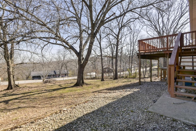 view of yard with a wooden deck and stairway