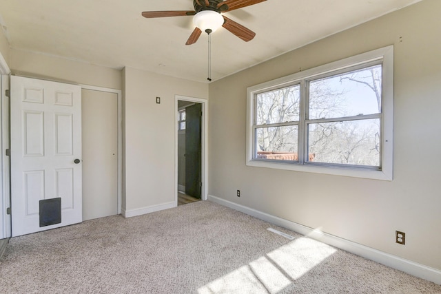 unfurnished bedroom featuring a closet, baseboards, carpet, and a ceiling fan