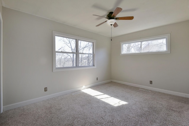 unfurnished room featuring carpet flooring, a ceiling fan, and baseboards