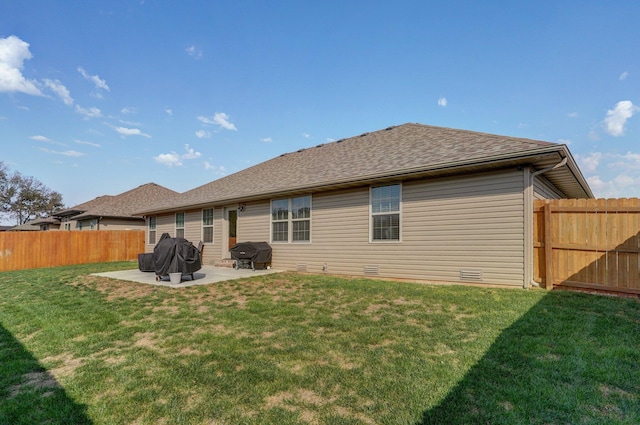 rear view of house featuring a lawn, a patio, a fenced backyard, a shingled roof, and crawl space